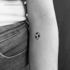 a small soccer ball tattoo on the arm