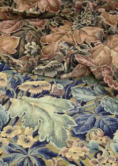 the fabric is very colorful and has many flowers on it, as well as leaves