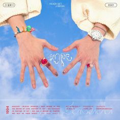 two hands holding each other in front of a blue sky with the word love written on it