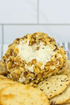 crackers with cheese and nuts are on a plate