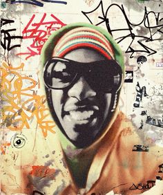 a man wearing sunglasses and a colorful hat with graffiti on the wall behind him,