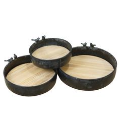 three round wooden trays sitting on top of each other