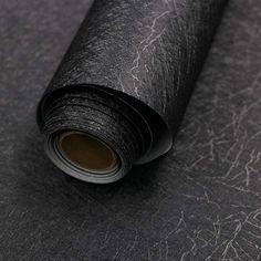 a roll of black paper sitting on top of a table