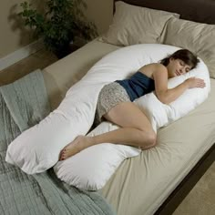 a woman is sleeping on a pillow in the middle of her bed, and it's time to sleep