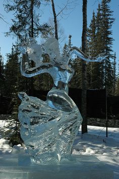 an ice sculpture of a woman in the snow