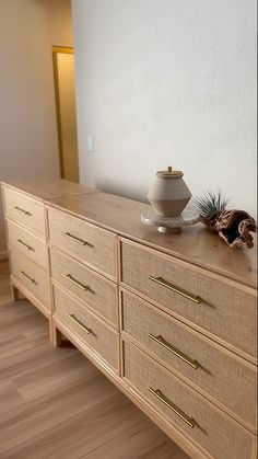 a large wooden dresser sitting in front of a white wall