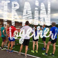 several people standing on the side of a soccer field with words written in front of them