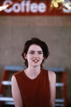 a woman standing in front of a coffee shop