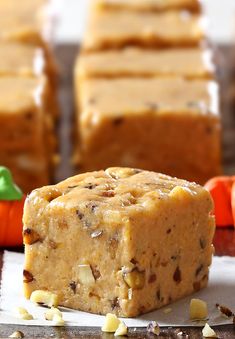 a close up of some kind of food on a table with carrots in the background