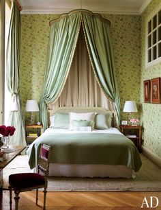 a bedroom with green walls and curtains on the windowsills is pictured in this image