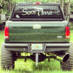 the back end of a pick up truck parked on grass