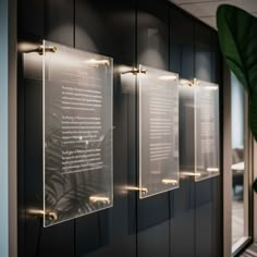 three glass plaques on the wall in an office