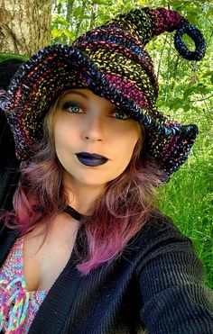 🌟FREE SHIPPING Need a fun accessory to spice up your Halloween costume this year? Thinking about attending a Cosplay event? Then this twisted witch/wizard hat is perfect for you!  Hat is stirched up in 100% acrylic black & "galaxy" color yarn!!.  Stuffed at the top for a sturdy yet flexible hold!  Hat also features a rhinestone star and glittery moon charm on the tiptop. Available in size: Adult Med: 21"-22" If you prefer changing any colors in this item that are not listed, please message me b Crochet Twisted Witches Hat Pattern Free, Crochet Modern Witch Hat, Small Crochet Witch Hat, Halloween Crochet Witch Hat, Crochet Whimsical Witch Hat, Galaxy Colors, Halloween Witch Hat, Witch Costume, Slouch Hat