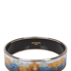 Hermes "Safari" printed enamel wide bracelet size GM (70) with silver plated hardware. This rare, retired "Safari" printed enamel bracelet uses earthy, neutral colors on a blue background depicting a pride of lions in its natural environs with silver plated rims. Origin: Austria Condition: Preloved - Excellent. The bracelet has no visible signs of wear on the enamel. The hardware rim is shiny with visible surface scratches. Accompanied by: Hermes box Measurements: 2.75" Diameter x 1" Width Pride Of Lions, Lion Pride, Hermes Jewelry, Hermes Box, Wide Bracelet, Gold Ounce, Enamel Bracelet, Bracelet Sizes, Blue Background