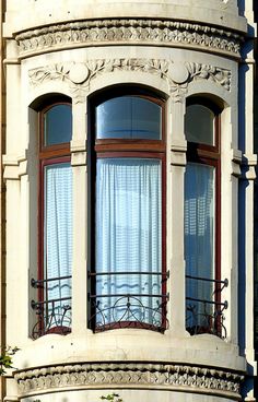 an old building with two balconies and windows