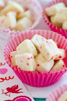 pink and white cupcakes with sprinkles on them