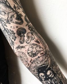 an arm with many different tattoos on it