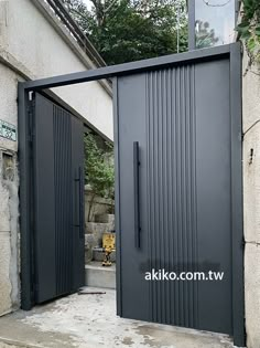 an entrance to a building with black doors