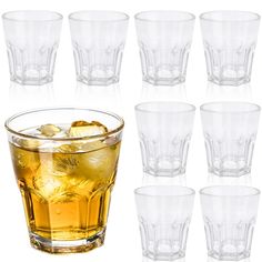 a set of six glasses filled with liquid and ice cubes next to each other