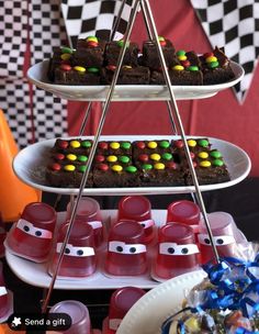 desserts are displayed on three tiered trays at a race themed birthday party