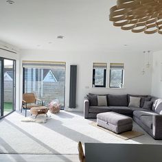 a living room filled with furniture and windows