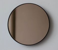 a round mirror hanging on the wall