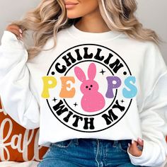 a woman wearing a white sweatshirt with the words chillin'peps with my on it