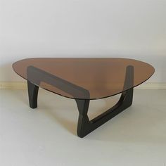 an oval glass coffee table with black legs