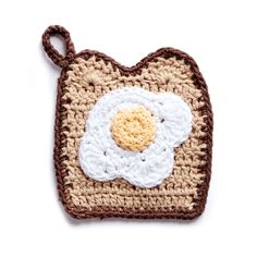 a crocheted square with an egg in the center