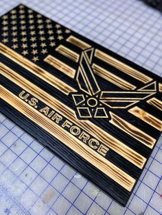 the us air force emblem is engraved on a wooden plaque