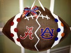 a football shaped door hanger with the letters auburn and a red, white, and blue design on it