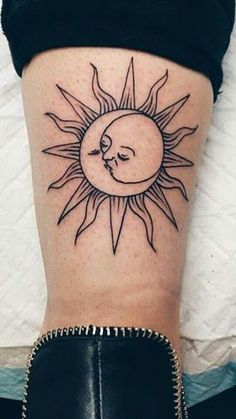 a woman's leg with a sun and moon tattoo on her left side calf