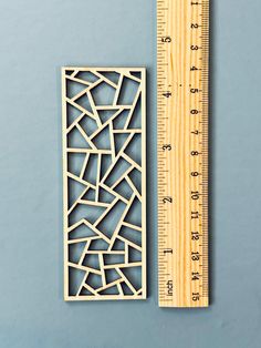 a ruler next to a cut out piece of wood