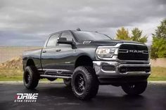 a large gray truck parked on top of a parking lot