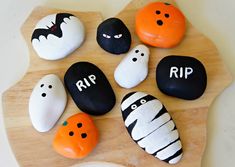 halloween rocks are decorated with black and white pumpkins, ghost faces, and the words rip on them