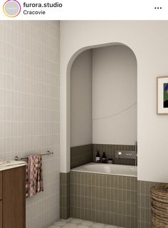 a bathroom with a tub, sink and mirror next to a painting on the wall