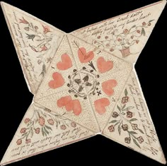 an origami star with hearts and flowers on the sides, decorated with writing