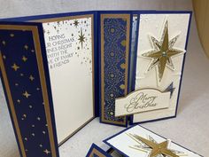 an open christmas card with gold stars on it and two cards that say merry christmas