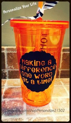 a plastic cup with a straw sticking out of it's lid that says making a difference one word at a time