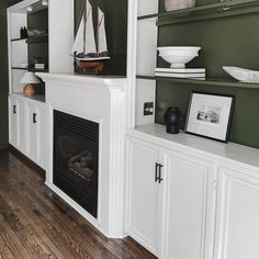 a living room filled with furniture and a fire place next to a wall mounted tv