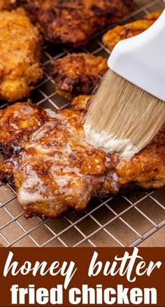 a spatula is being used to brush off the fried chicken