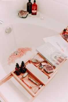 a bath tub with soaps and bottles on it