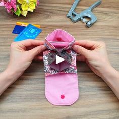 someone is making an origami flower out of a pair of pink slippers