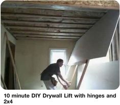 a man is painting the ceiling in his house with drywalls and insulation tape