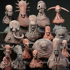 an assortment of strange looking heads and body sculptures on top of each other in various shapes and sizes