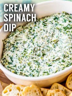 creamy spinach dip in a white bowl with crackers on the side and text overlay