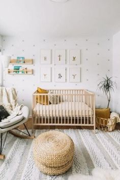 a baby's room with a rocking chair, crib and pictures on the wall