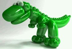 an inflatable green alligator is standing upright