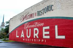 a large sign on the side of a building that says, welcome to historic laurell mississippi