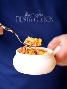 a person holding a bowl of food with a spoon in it and the words above it